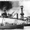 The USS Oklahoma, crews working to save the trapped sailors. USS Maryland in the background. Photo from the Naval History & Heritage Command.